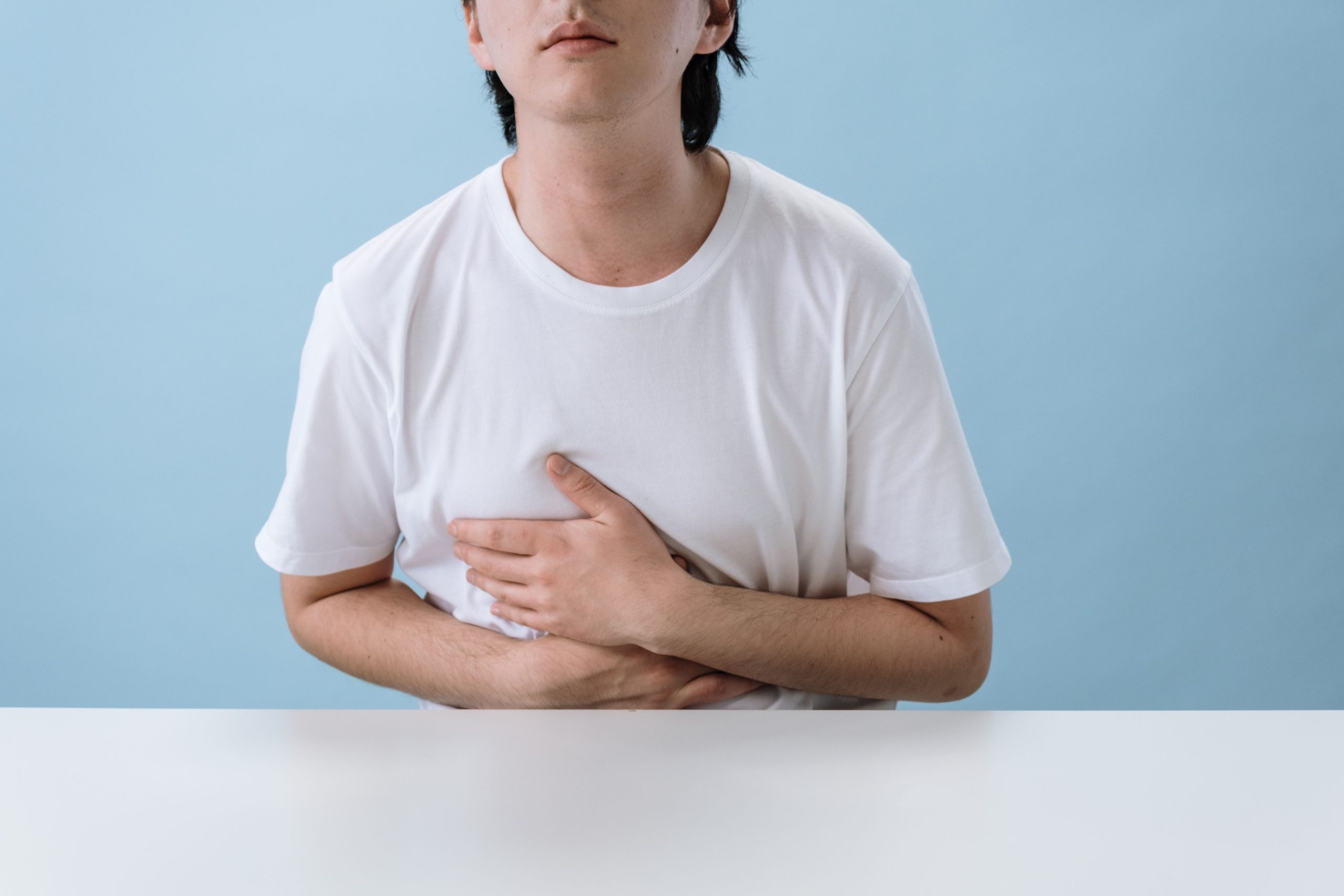 Homme tenant son estomac indiquant une douleur