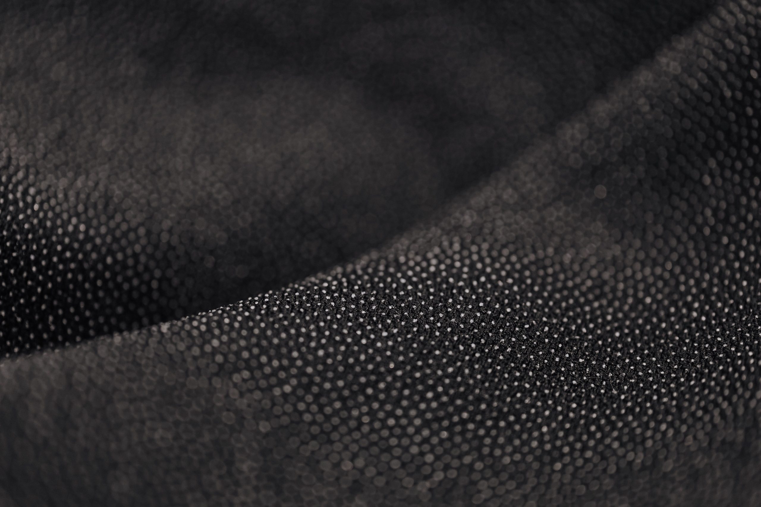 Macro tissu noir pointillé motif intriqué